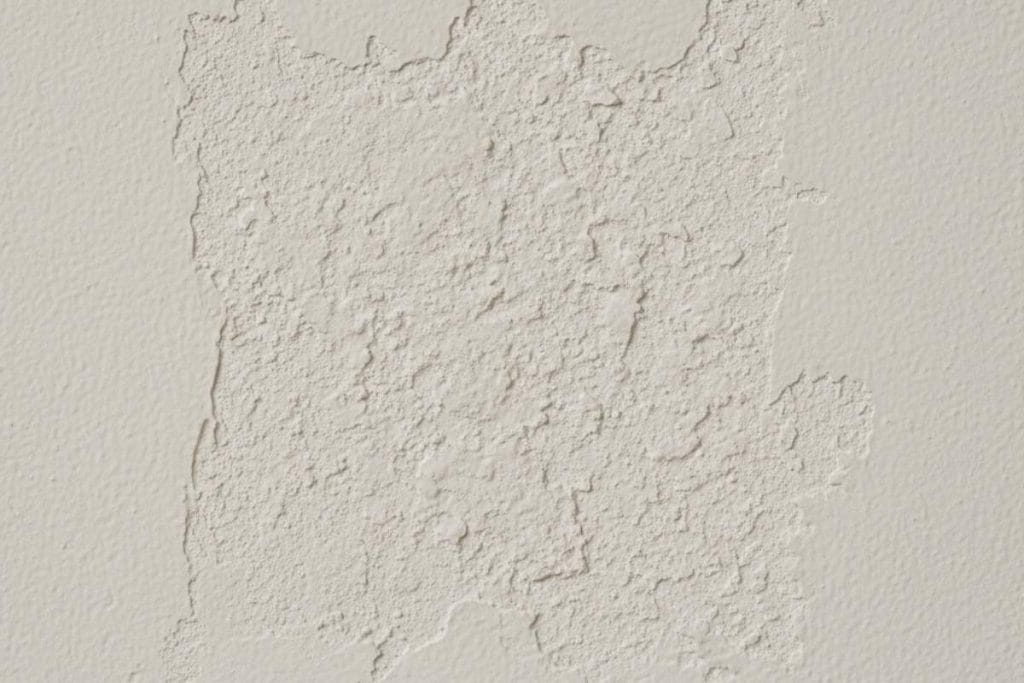 Textured wall patching compound on drywall (possible asbestos-containing material in older homes)